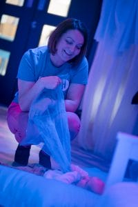 Dreamland Creative Play at The Hullabaloo. Hullabaloo Host holding scarf to baby