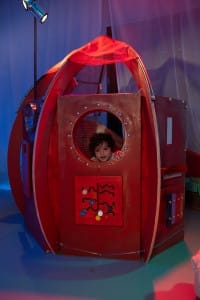 The red rocket with a little girl peeping through the circle window