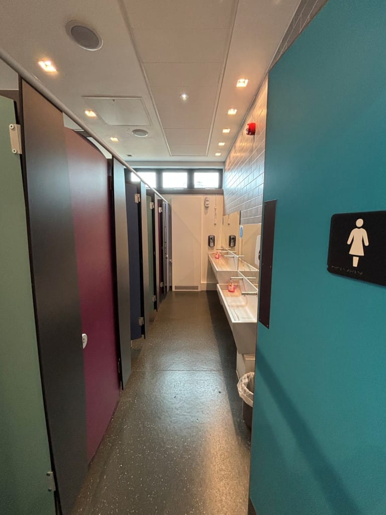 The ladies toilets with 6 individual cubicles, a raised sink and low sink. 