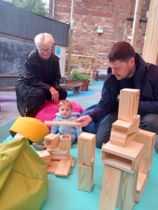 Family of 3 playing together in our outdoor space
