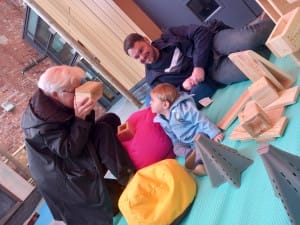 Family of 3 playing with new blocks in the outdoor space