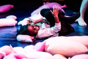 A little girl laying on the floor smiling