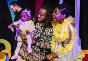 A boldly dressed Take Flight actress with 2 members of the audience
